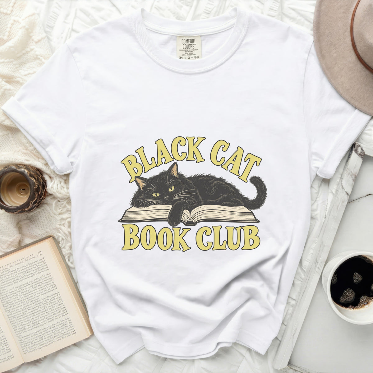 White t-shirt with black cat on open book graphic, reading "Black Cat Book Club".