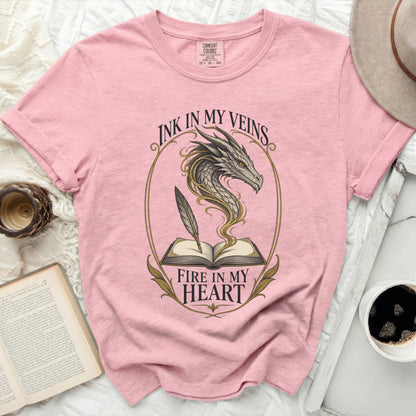 Pink t-shirt with dragon and book design featuring text "Ink in my veins Fire in my heart."