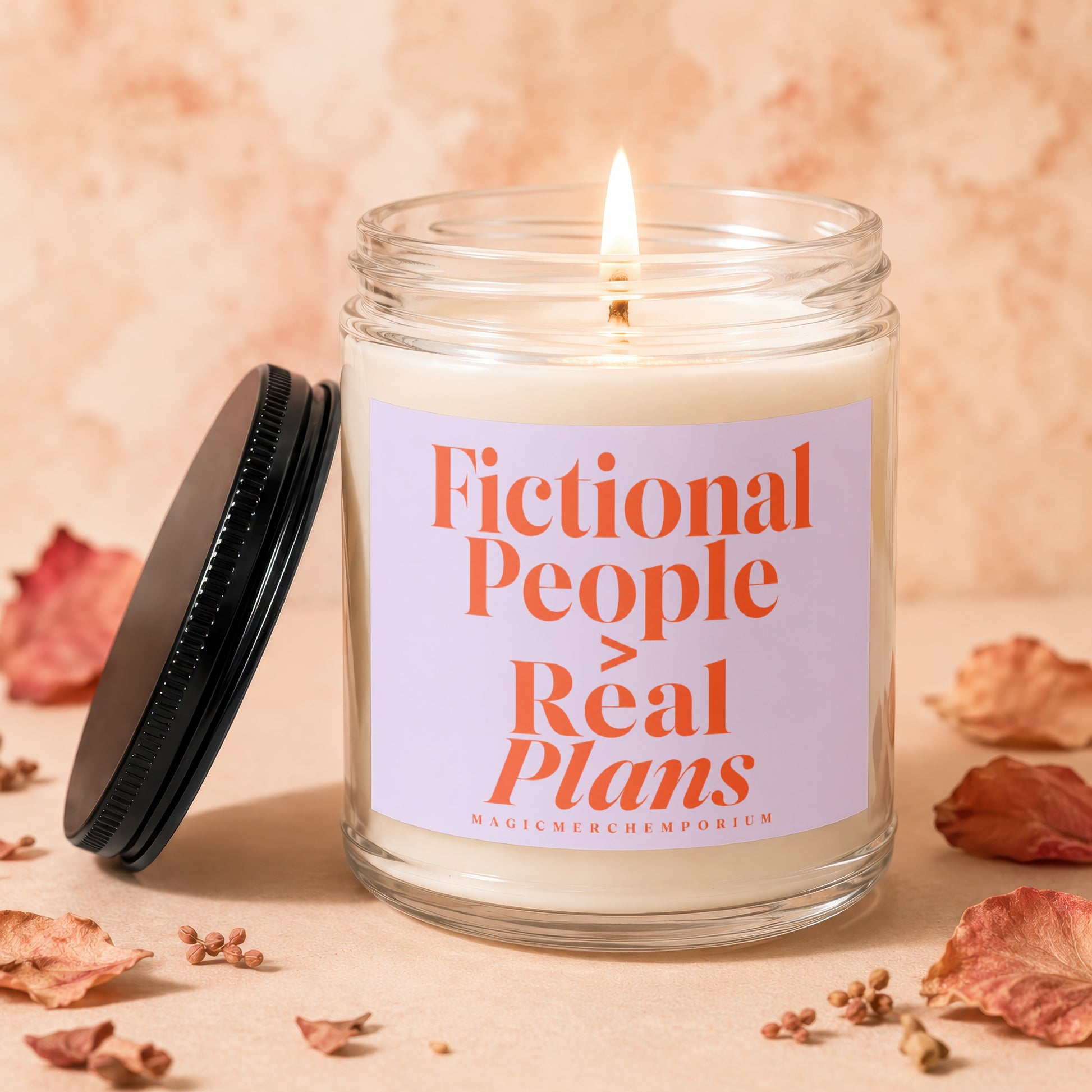 Lit candle with "Fictional People > Real Plans" text on label.