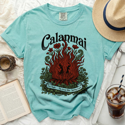 Aqua t-shirt with a graphic of flames, flowers, and the text "Calanmai Fire Night - The Great Rite - Spring Court".
