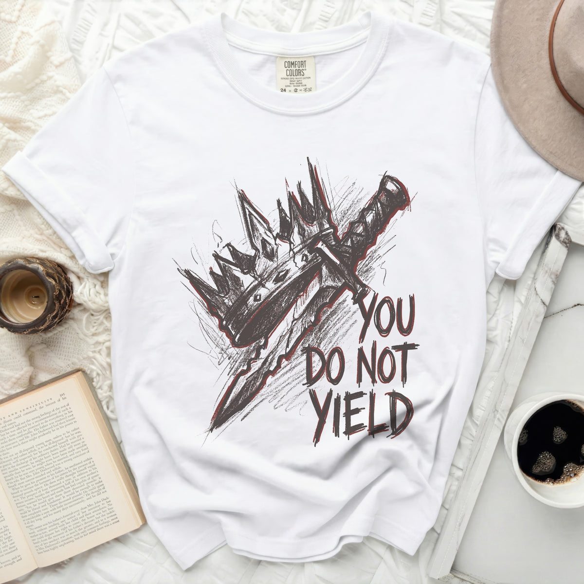 White t-shirt with sketch of crown and sword, text "YOU DO NOT YIELD"