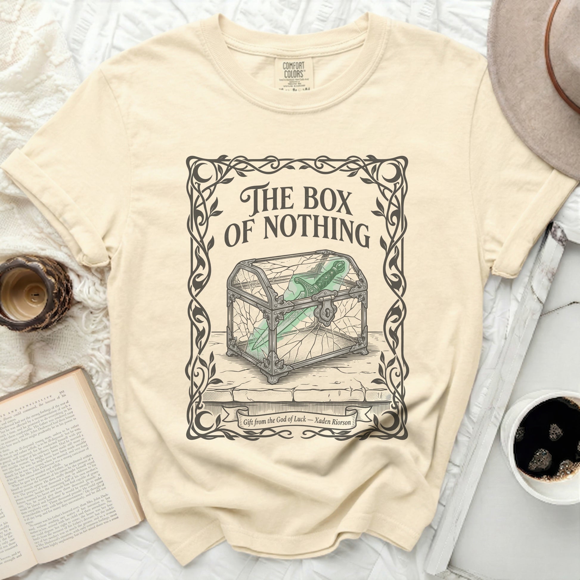 Cream t-shirt with "The Box of Nothing" graphic and a cracked glass box.