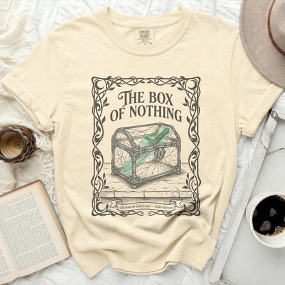 Cream t-shirt with "The Box of Nothing" graphic and a cracked glass box.