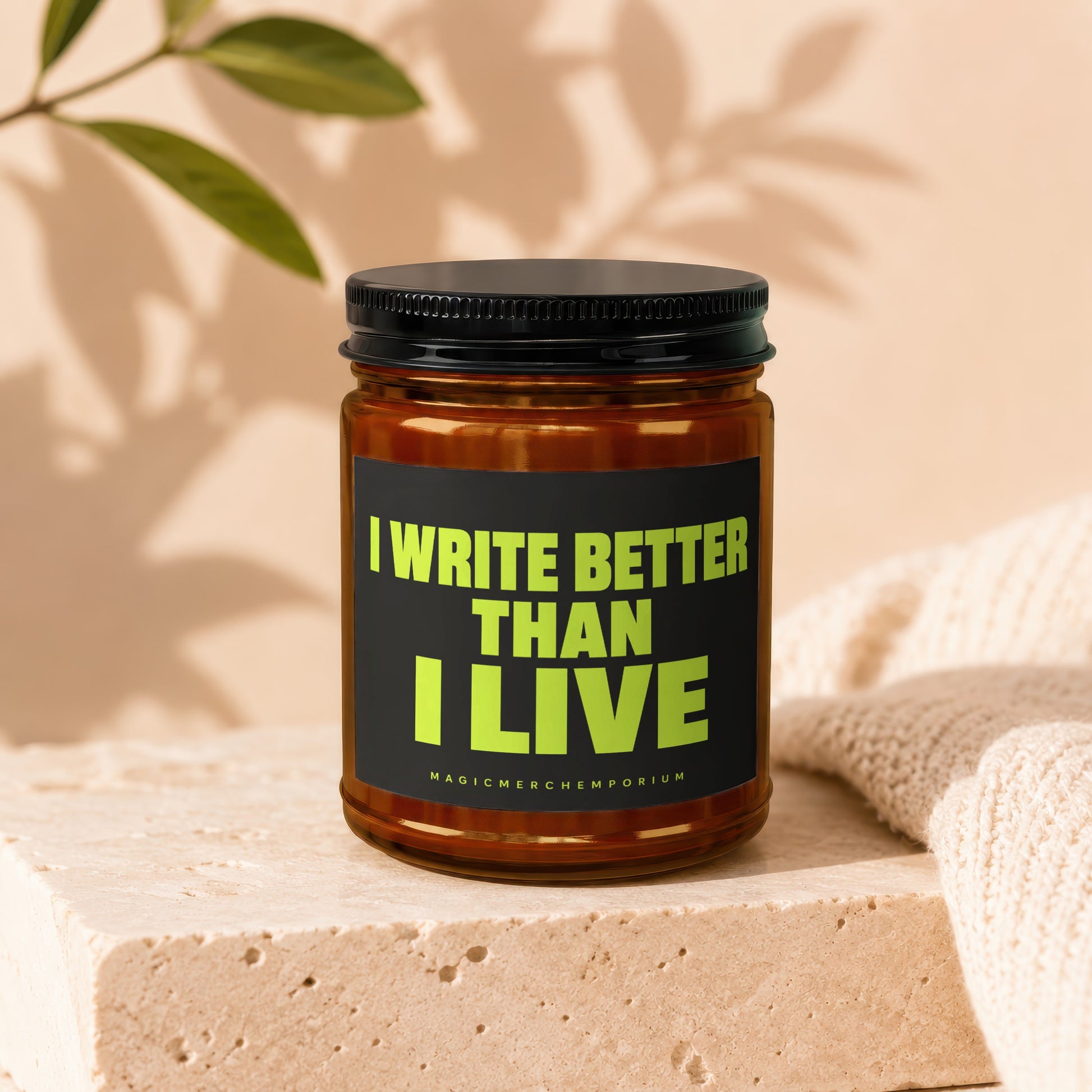 Amber jar with black lid, features the text "I WRITE BETTER THAN I LIVE".