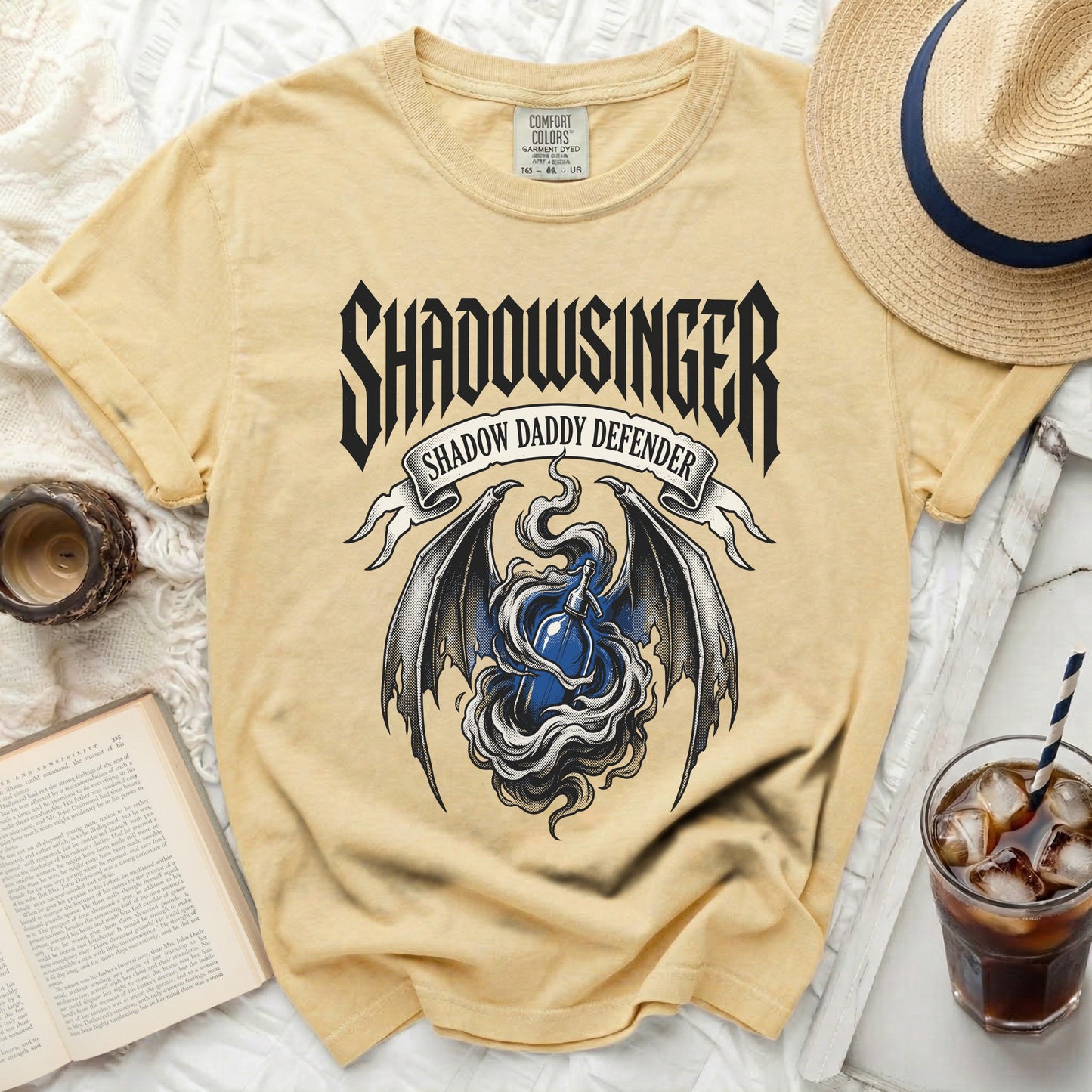 Yellow t-shirt with black "Shadowsinger" text and dragon wings graphic.
