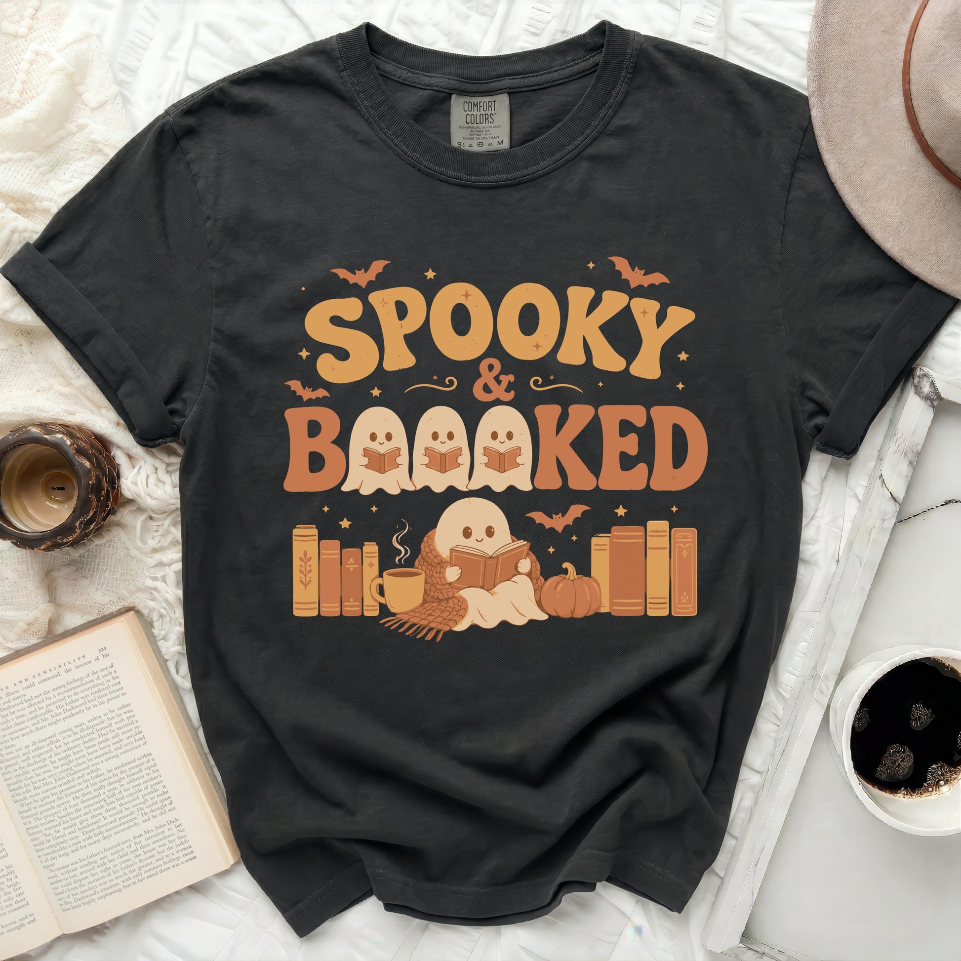 Spooky & Booked t-shirt with ghosts reading books and Halloween icons.