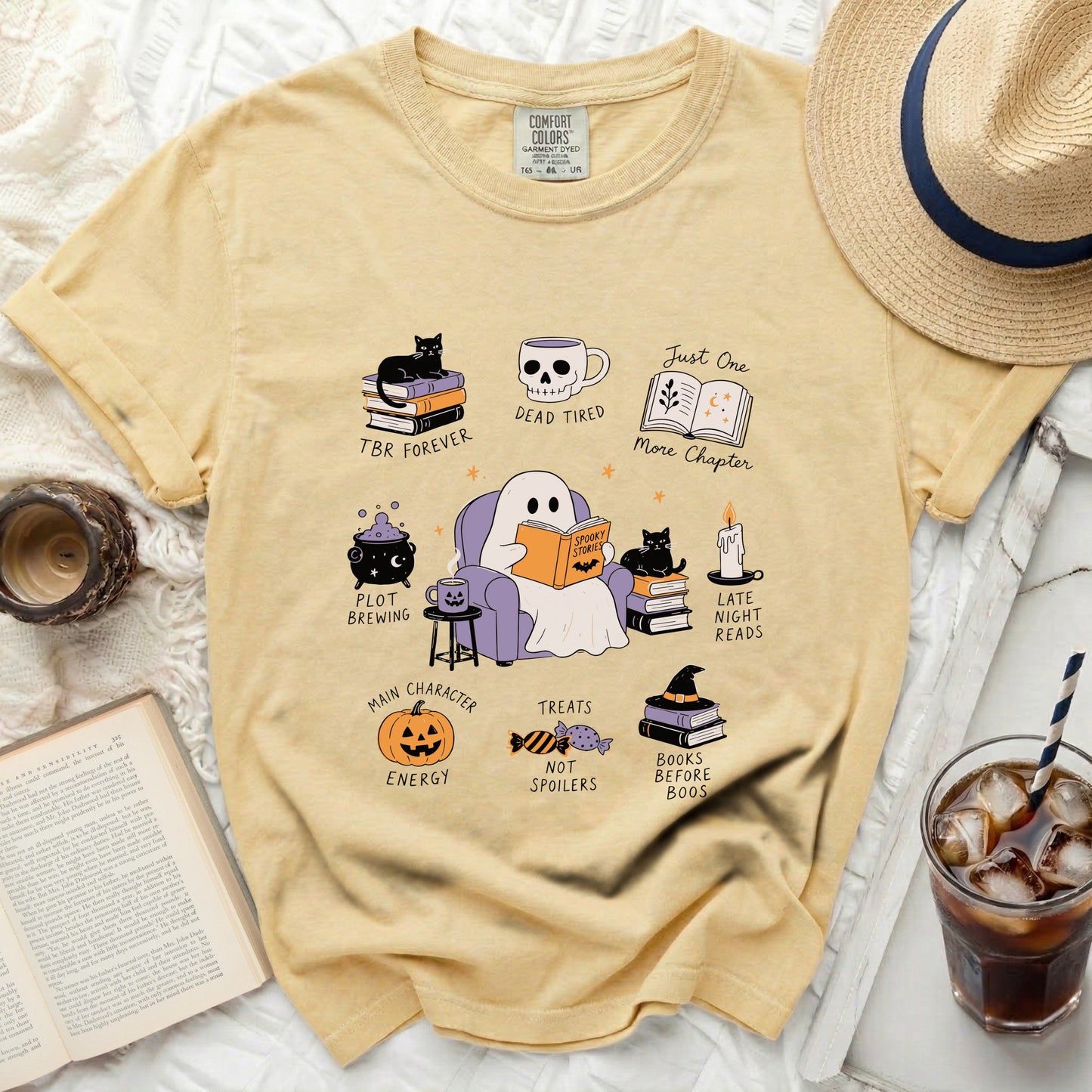 Yellow t-shirt with ghost reading and Halloween-themed book illustrations.