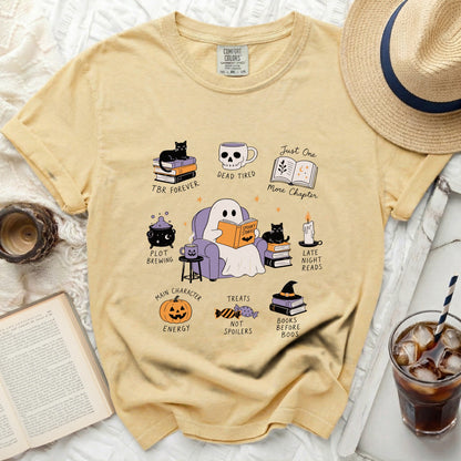 Yellow t-shirt with ghost reading and Halloween-themed book illustrations.