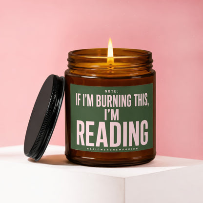 Amber jar candle with lit flame and black lid, reads "Note: If I'm Burning This, I'm Reading"