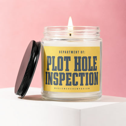 Glass jar candle with yellow label reading "DEPARTMENT OF: PLOT HOLE INSPECTION"