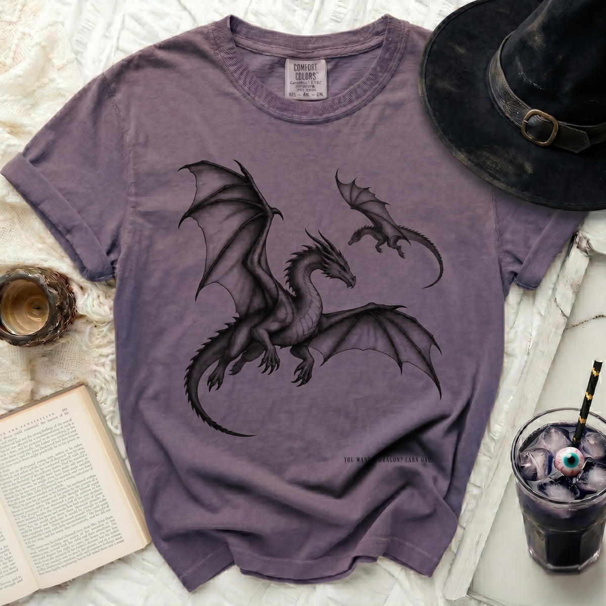 Purple t-shirt with two black dragons graphic and text "YOU WANT A DRAGON? EARN ONE."