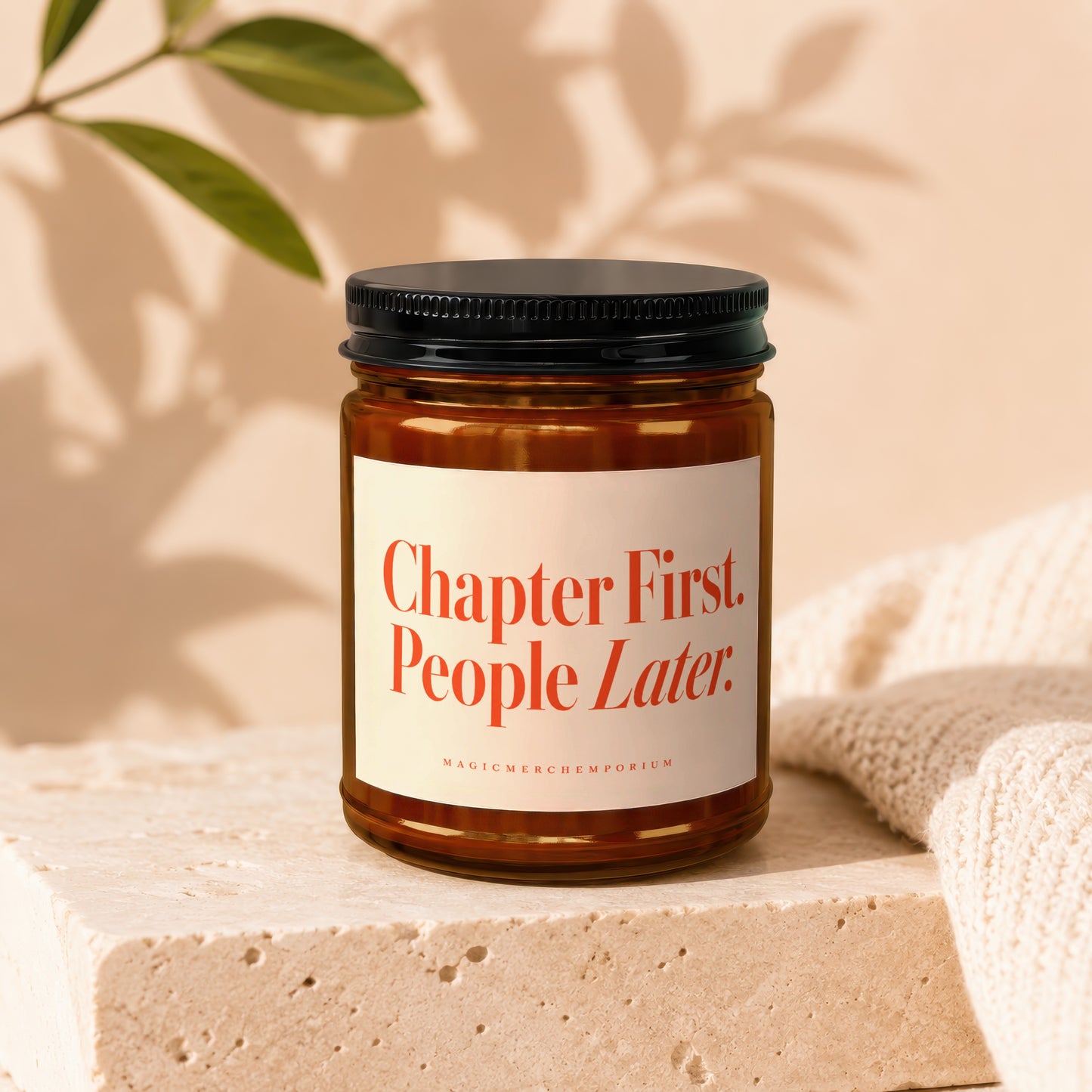 Amber candle with black lid and label reading "Chapter First. People Later."