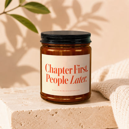 Amber candle with black lid and label reading "Chapter First. People Later."