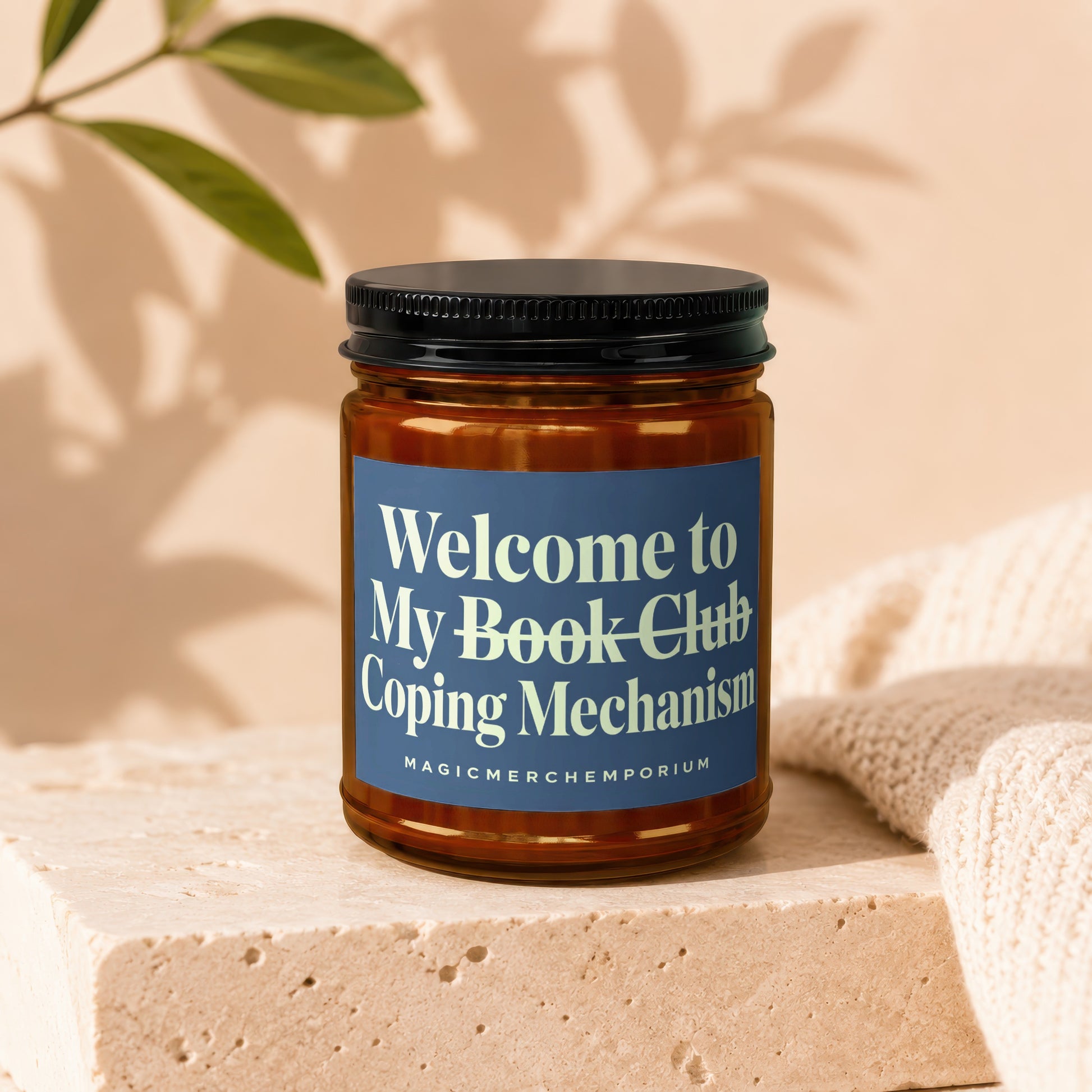Amber jar candle with a blue label reading "Welcome to My Book Club Coping Mechanism"