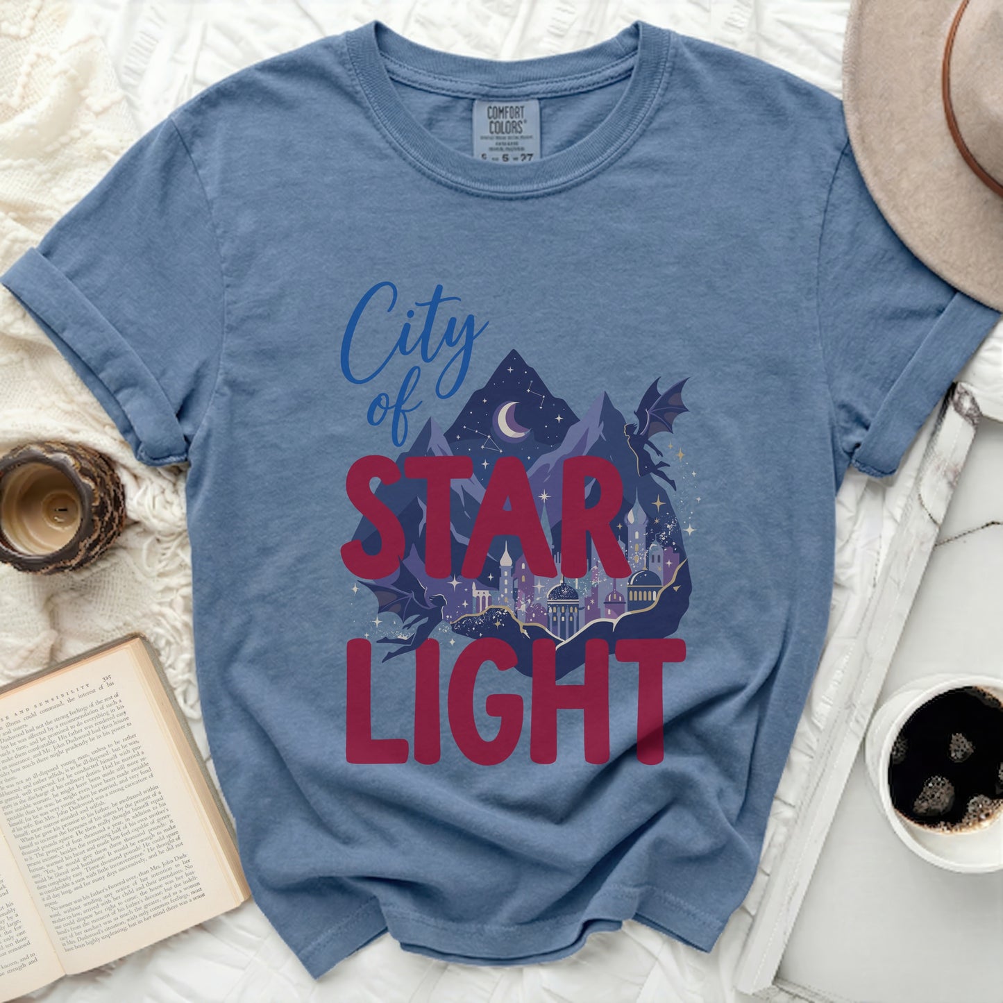 Blue t-shirt with "City of STAR LIGHT" graphic featuring a city, mountains, and dragons.