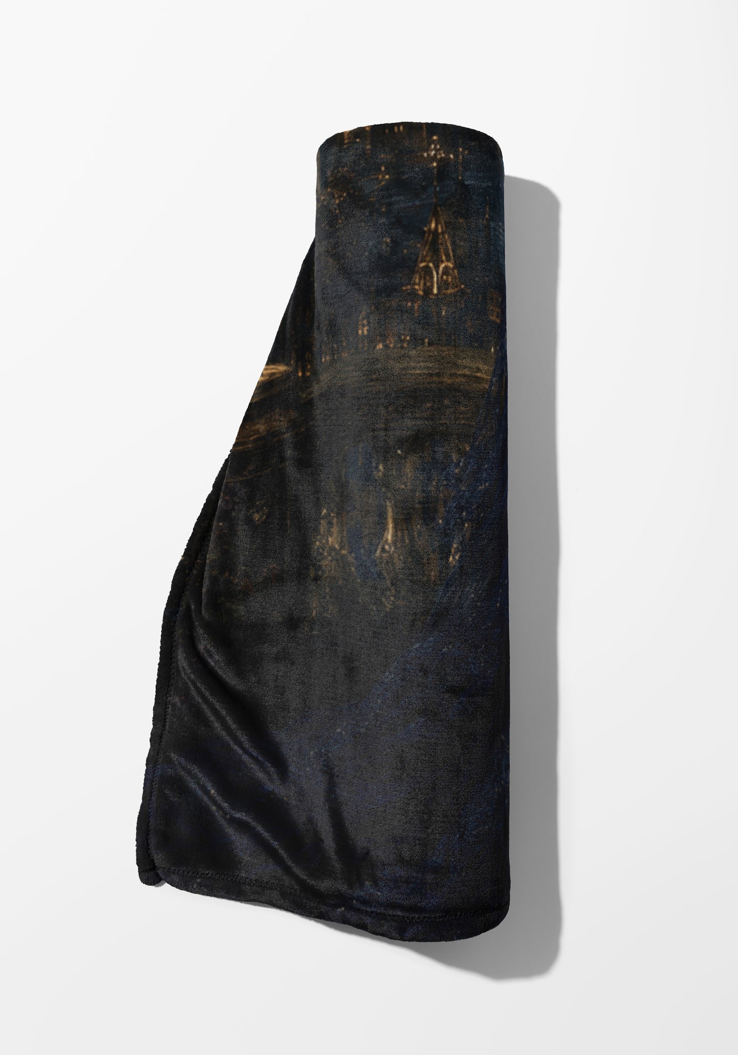 Dark rolled blanket with a nocturne cityscape design and golden lights.