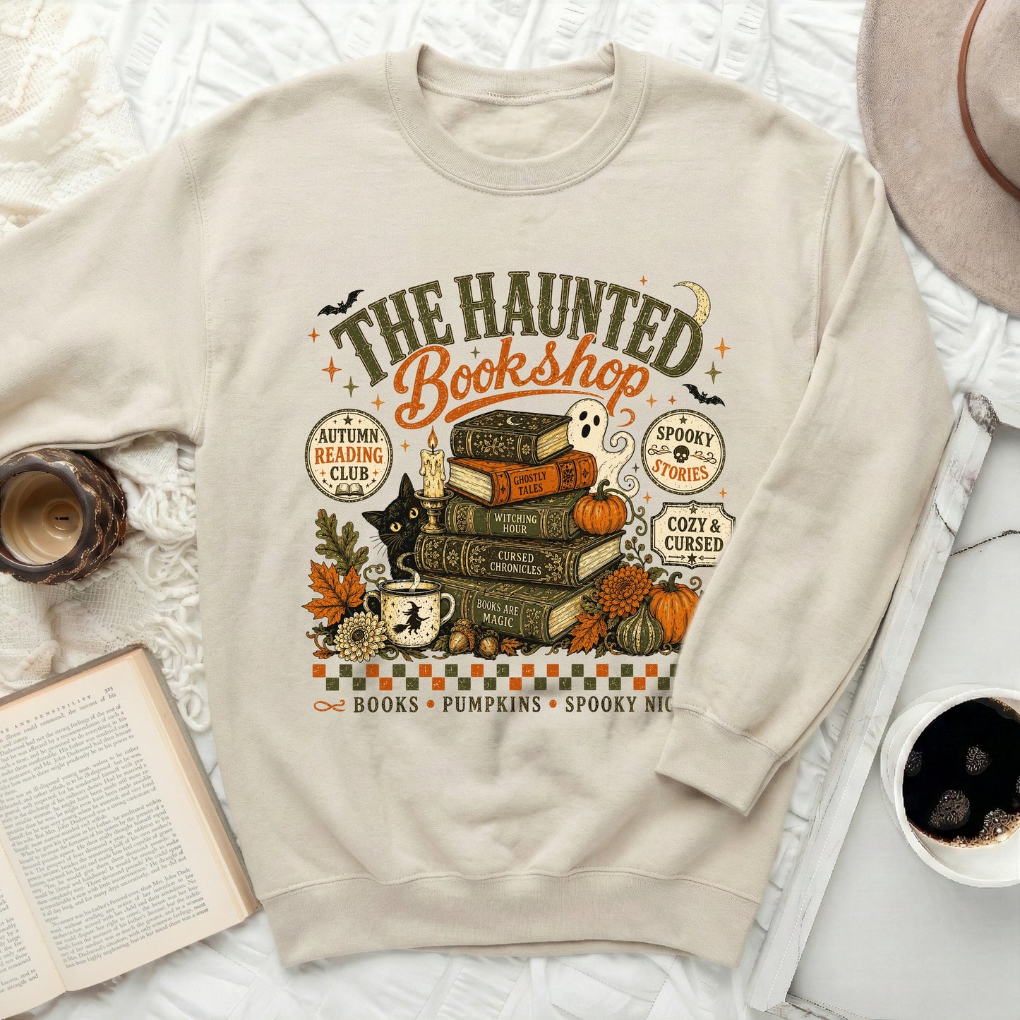 "The Haunted Bookshop" sweatshirt with Halloween-themed illustrations.