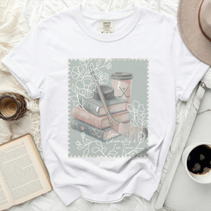 White t-shirt with a stamp graphic featuring books, hockey gear, and coffee.