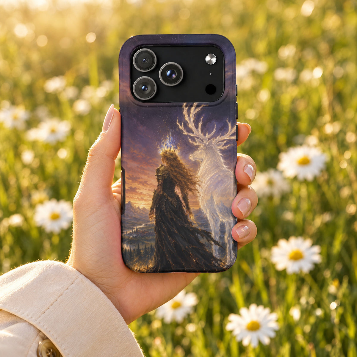 A hand holds a smartphone with a fantasy artwork case depicting a crowned woman and glowing stag.