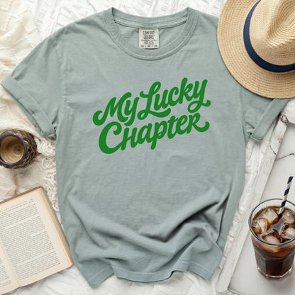 Green t-shirt with "My Lucky Chapter" in green script.