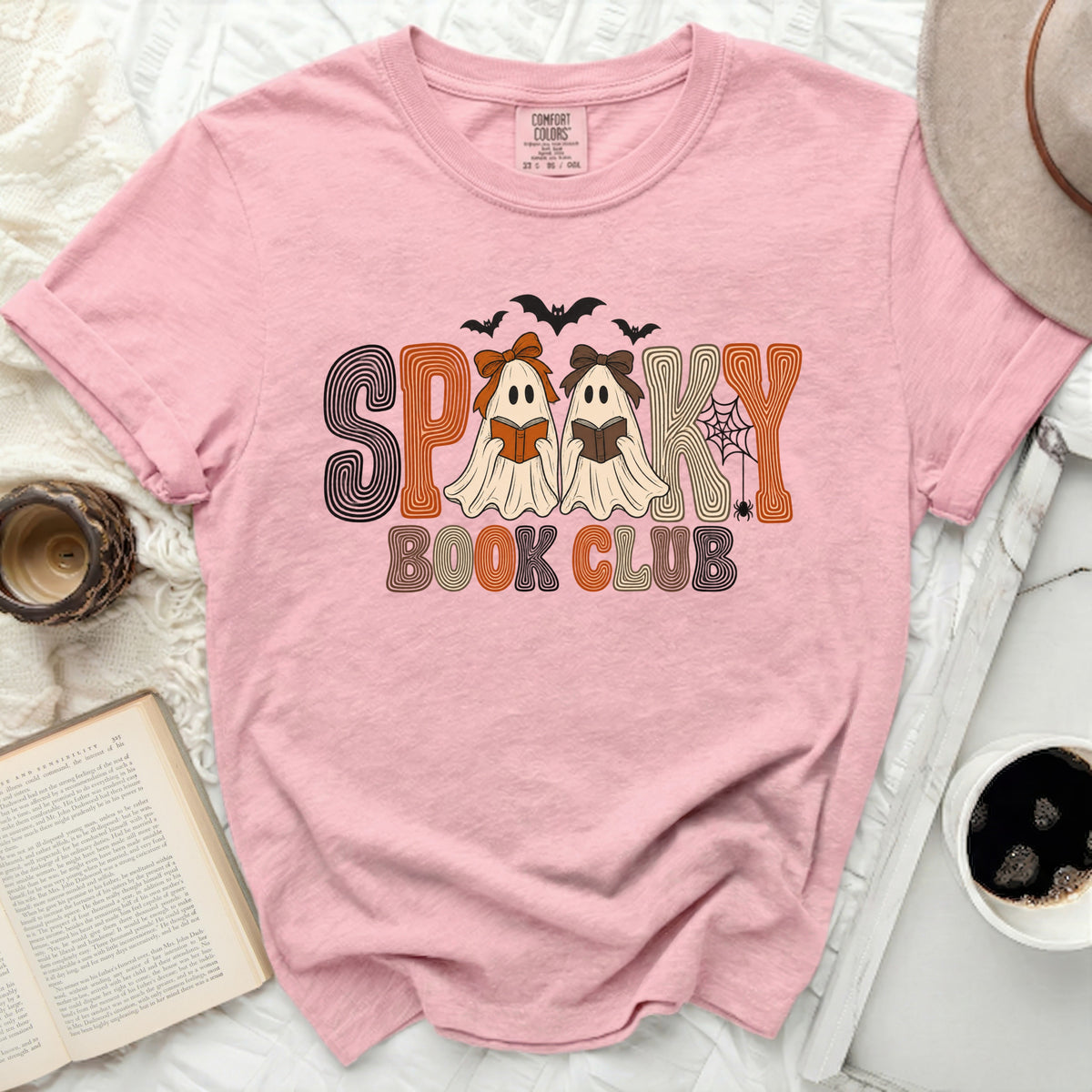 Pink t-shirt with "Spooky Book Club" text featuring ghosts reading books.