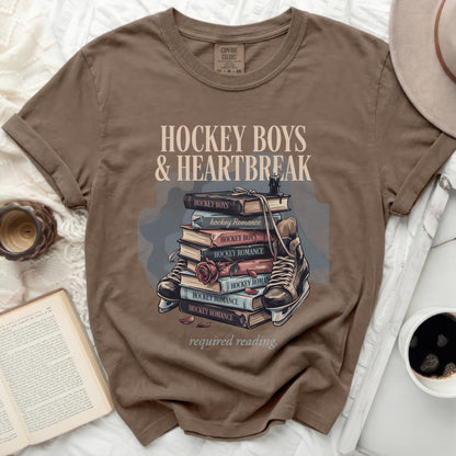 T-shirt with stacked books, roller skate, and "Hockey Boys & Heartbreak" text.