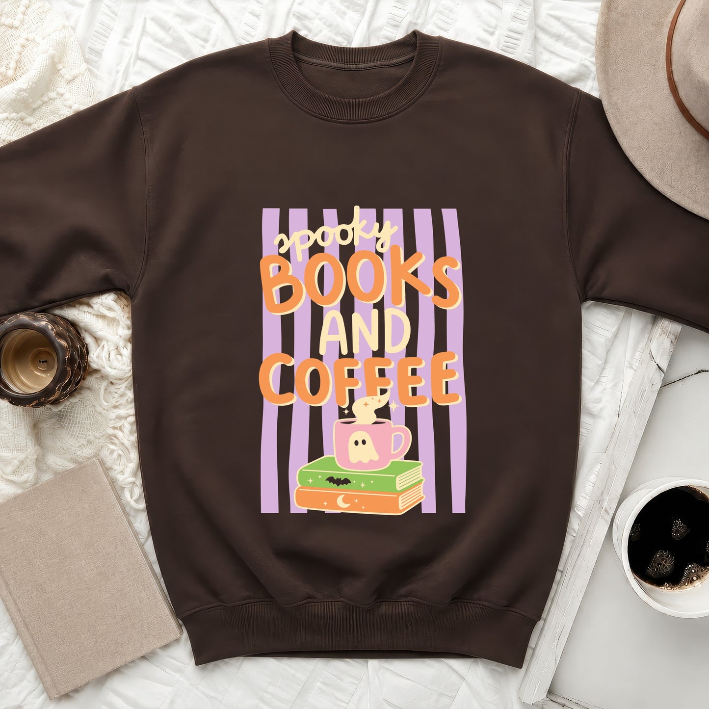 Brown sweatshirt with "spooky books and coffee" Halloween graphic and ghost mug.