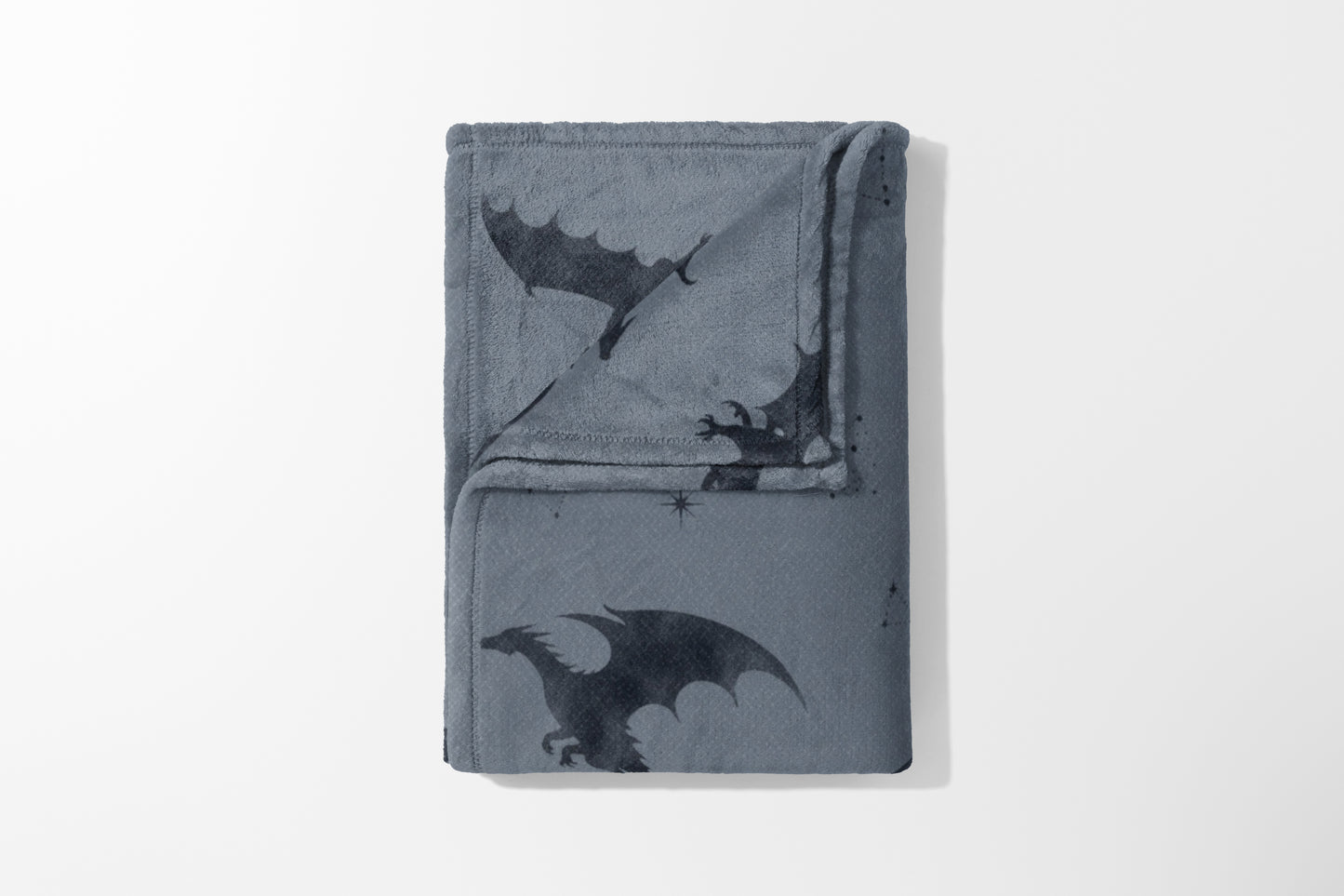 Gray fleece blanket with dark gray dragon and star pattern.