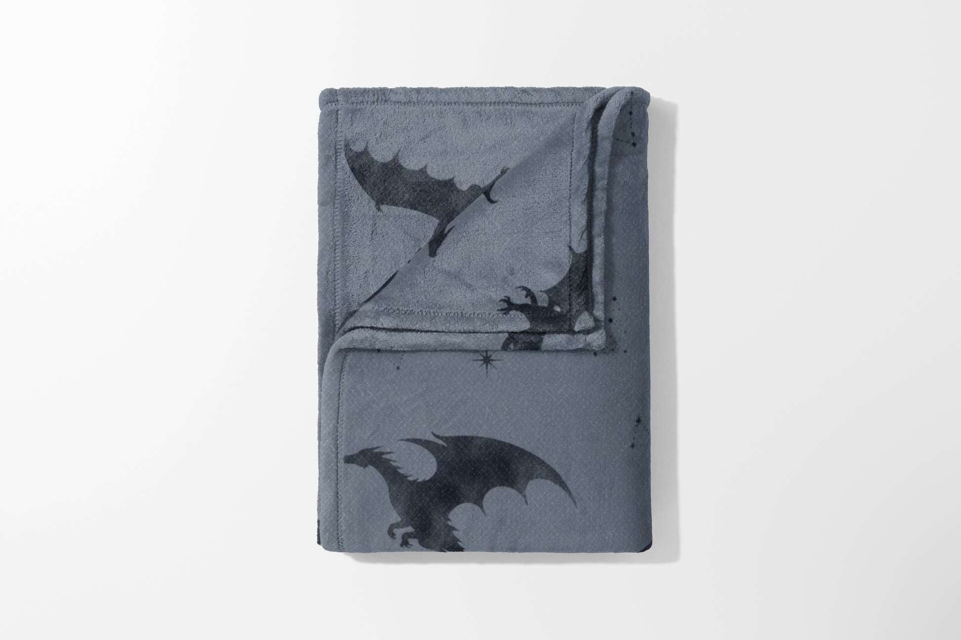 Gray fleece blanket with dark gray dragon and star pattern.