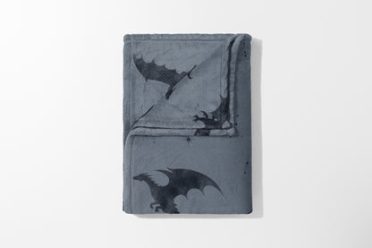 Gray fleece blanket with dark gray dragon and star pattern.