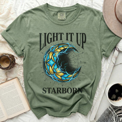 Green t-shirt with "LIGHT IT UP STARBORN" and a crescent moon design.