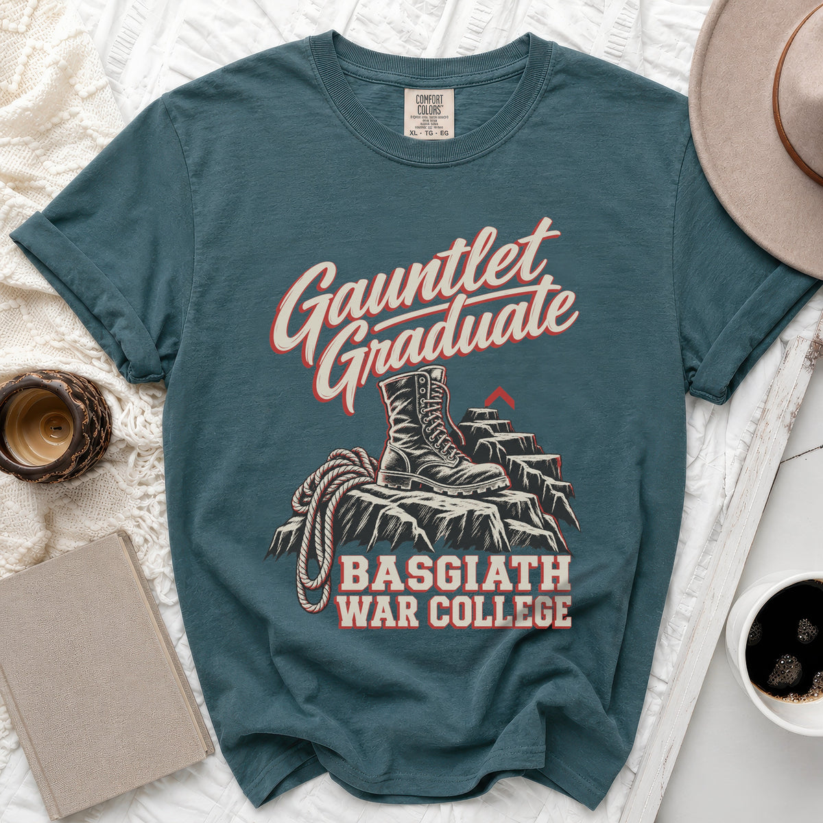 Teal t-shirt with "Gauntlet Graduate" text, combat boot on rocks, and "Basgiath War College."
