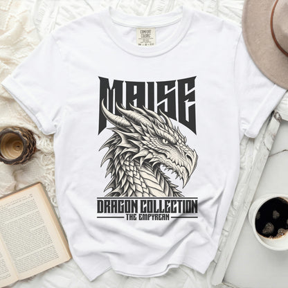 White t-shirt with a black dragon head graphic and text "MAISE DRAGON COLLECTION THE EMPYREAN".