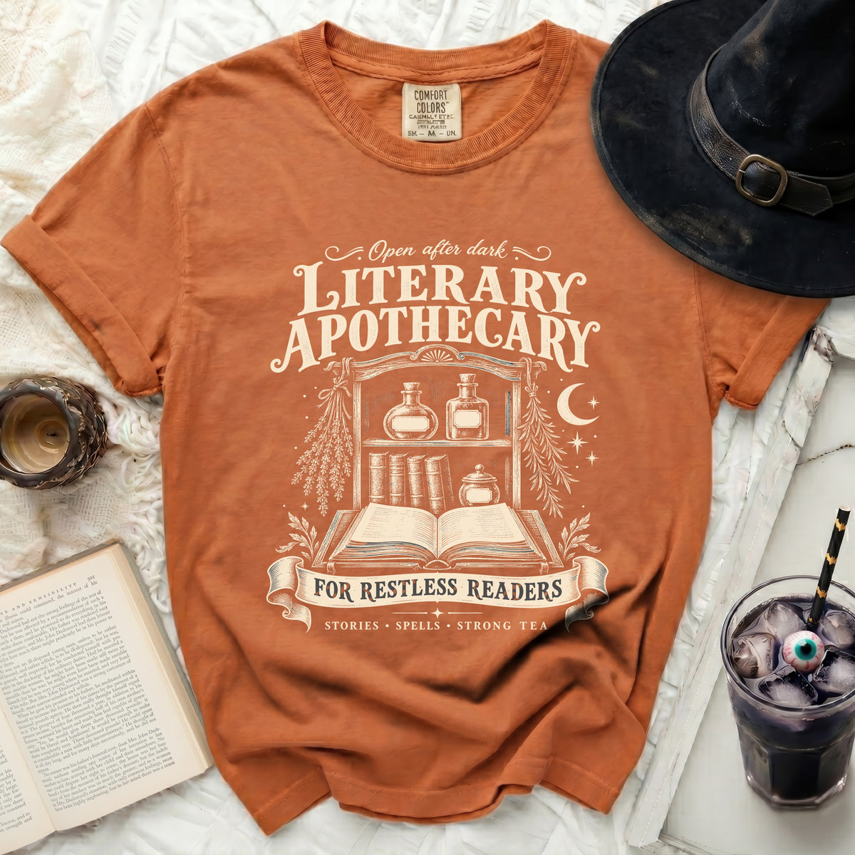Orange t-shirt with "Literary Apothecary" and "For Restless Readers" text.