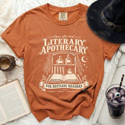 Orange t-shirt with "Literary Apothecary" and "For Restless Readers" text.