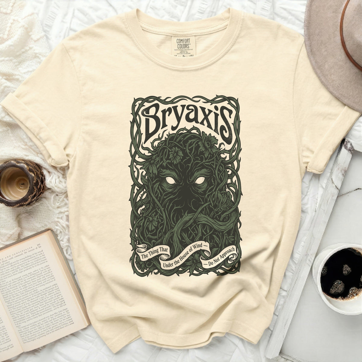 Bryaxis graphic tee with vines, flowers, and banner text.