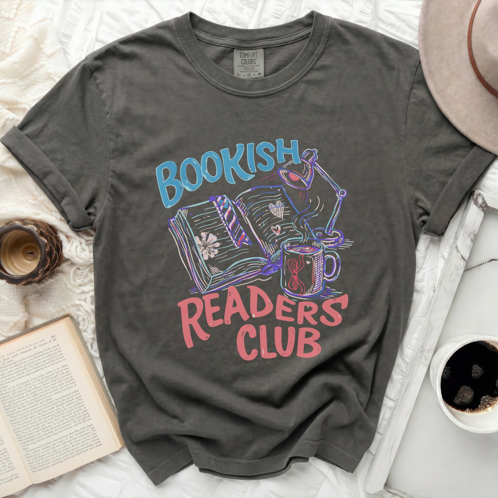 Bookish Readers Club graphic on dark gray t-shirt with books, lamp, and mug.
