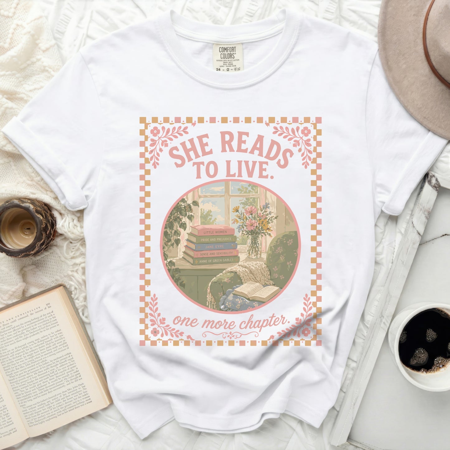 White t-shirt with "She Reads to Live. One More Chapter." and book titles.