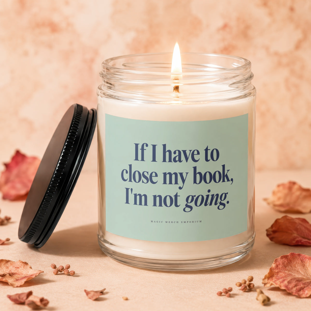 Candle with lit wick and text "If I have to close my book, I'm not going."