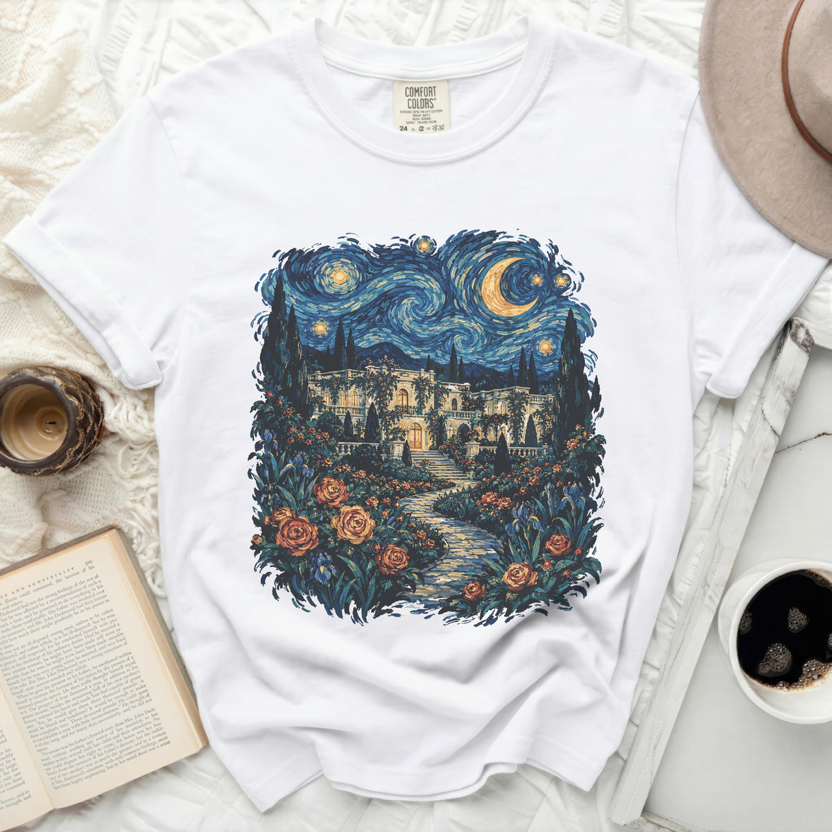 White t-shirt with a Van Gogh-inspired print of a mansion and starry night.