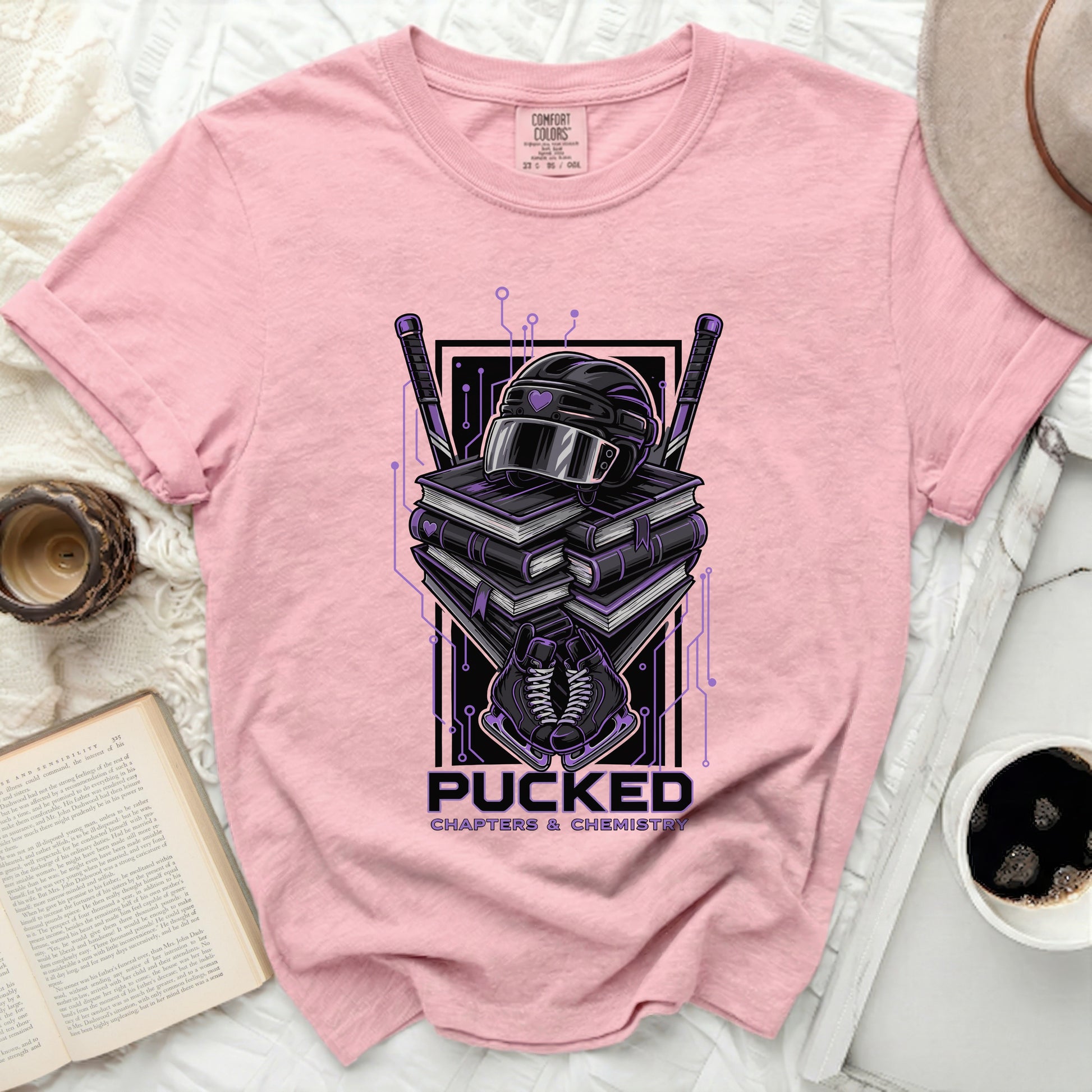 Pink t-shirt with "Pucked Chapters & Chemistry" hockey graphic.