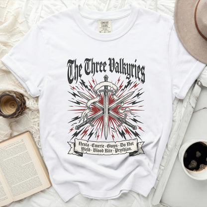 White t-shirt with "The Three Valkyries" and swords graphic.