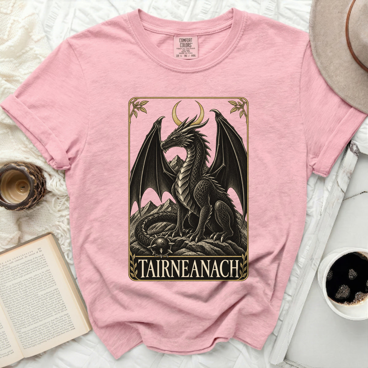 Pink t-shirt with a black dragon graphic and "TAIRNEANACH" text.