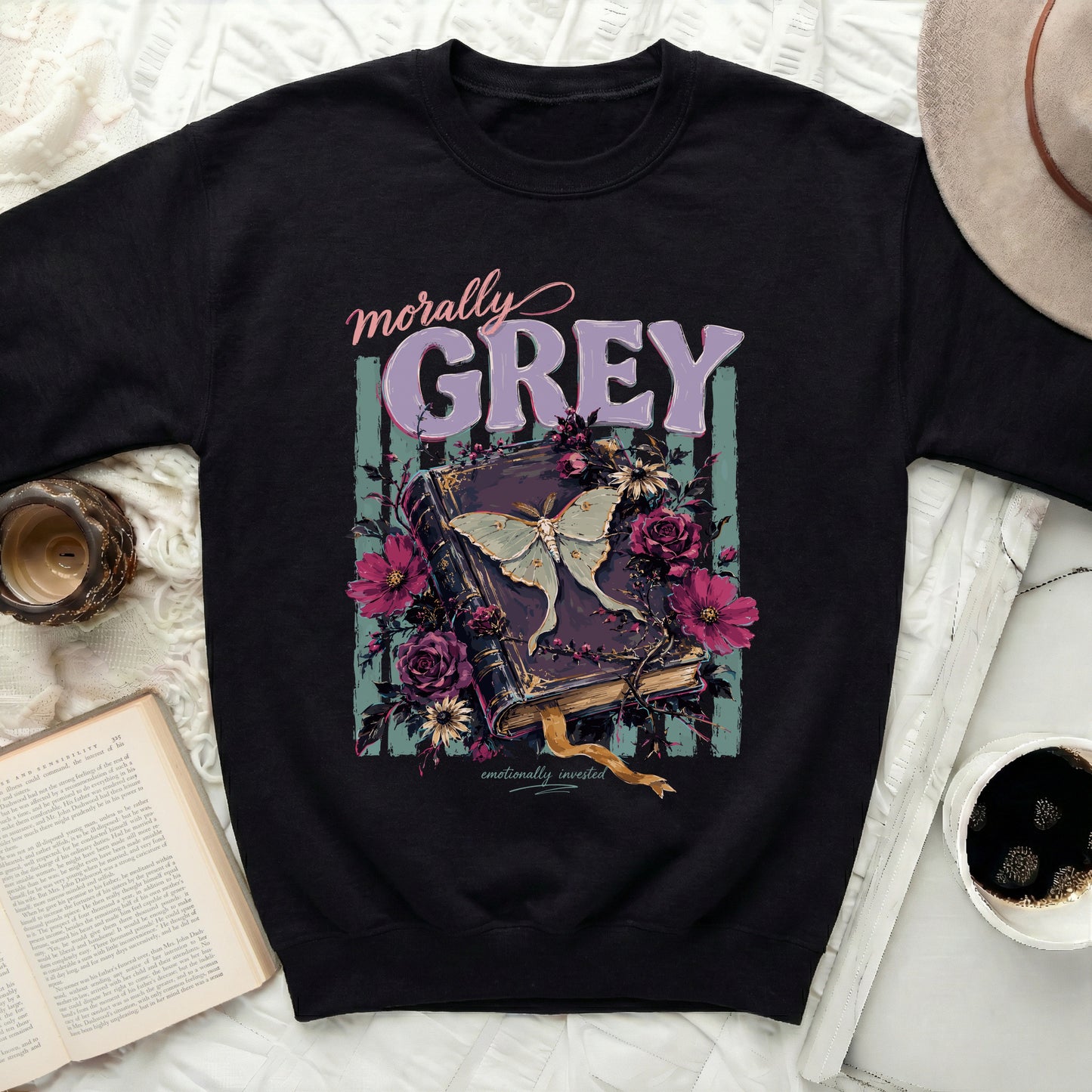 Black sweatshirt with "morally GREY" text over a moth and gothic book illustration.