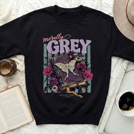 Black sweatshirt with "morally GREY" text over a moth and gothic book illustration.