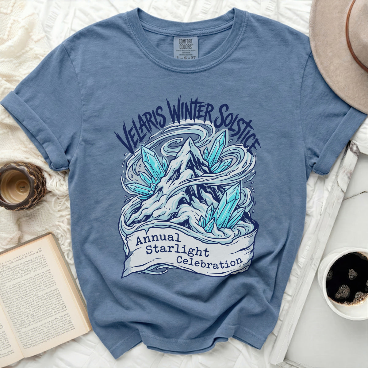 Blue t-shirt with "Velaris Winter Solstice Annual Starlight Celebration" graphic.
