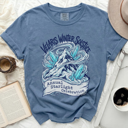 Blue t-shirt with "Velaris Winter Solstice Annual Starlight Celebration" graphic.