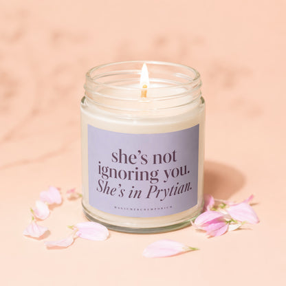Lit candle in jar with a lavender label reading "she's not ignoring you. She's in Prytian."