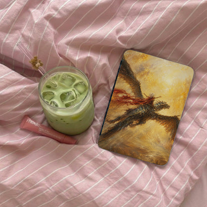 Laptop case with a dragon rider artwork, next to matcha ice drink and lip balm.