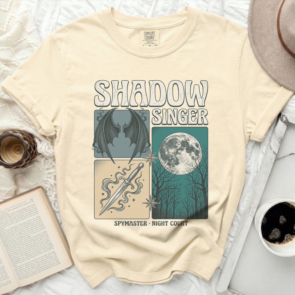 Cream Comfort Colors t-shirt with Shadow Singer, winged figure, dagger, and moon design.